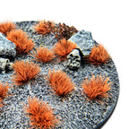 Neo-Titan Orange Martian Fluor Tufts planted on a grey textured base with a skull and rocks