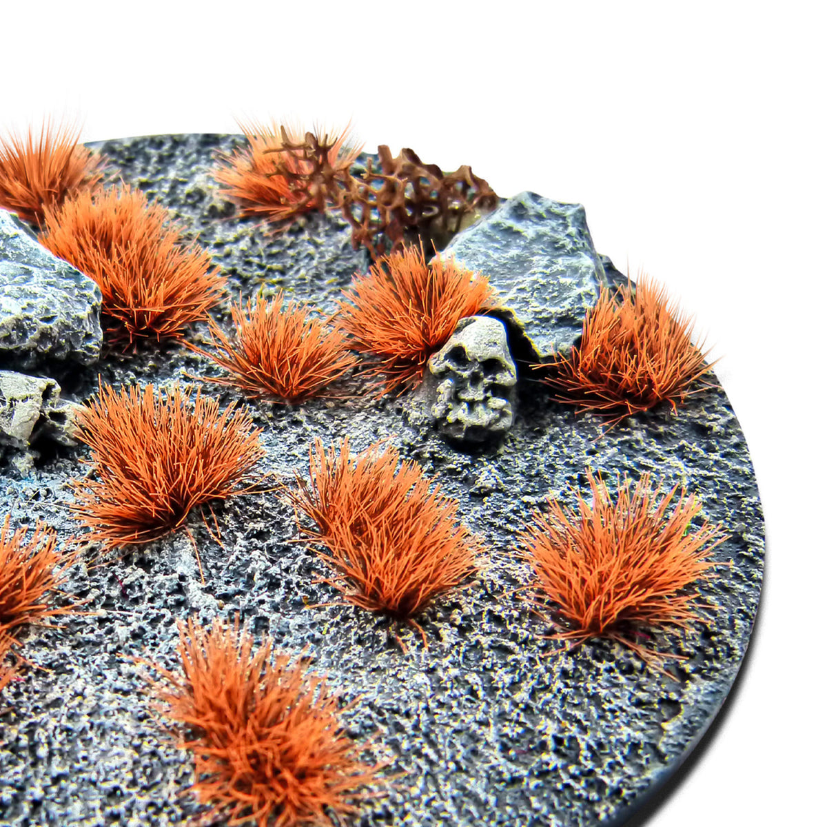 Neo-Titan Orange Martian Fluor Tufts planted on a grey textured base with a skull and rocks
