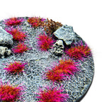 On Fire Purple Martian Fluor Tufts planted on a grey textured base with a skull and rocks