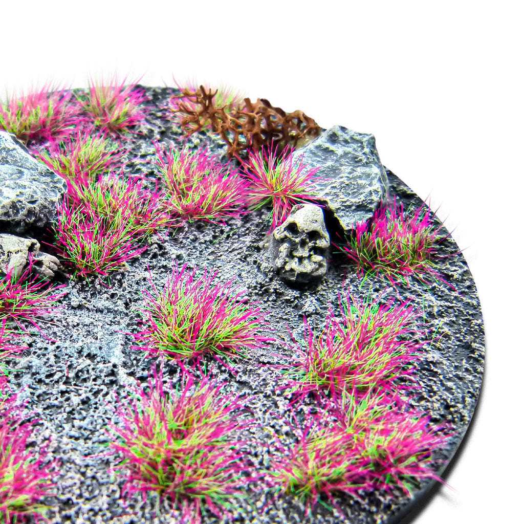 PunkPink Neon Martian Fluor Tufts planted on a grey textured base with a skull and rocks