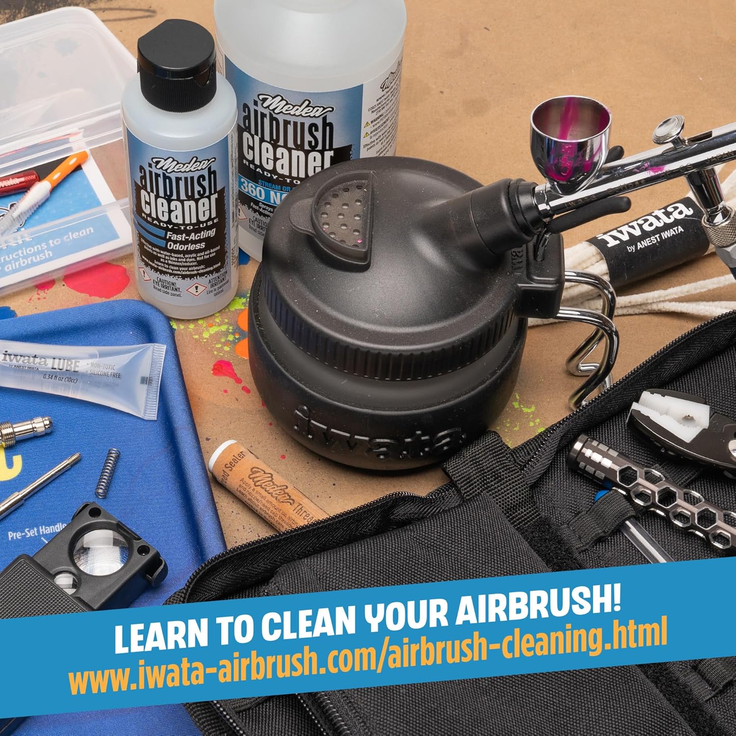 Medea Iwata Airbrush Cleaner displayed with artist tools and cleaning accessories