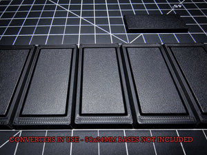 Closeup of OBS 50x24mm rectangular base fitted in a converter - Detailed view showing the precise fit and design of the conversion system for specific base sizes