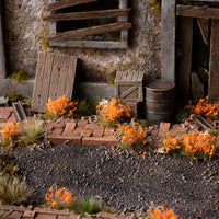 Lifelike diorama featuring Orange Flowers - Wild tufts, showcasing a vibrant landscape with varied textures, including colorful garden flowers and wild meadow blooms
