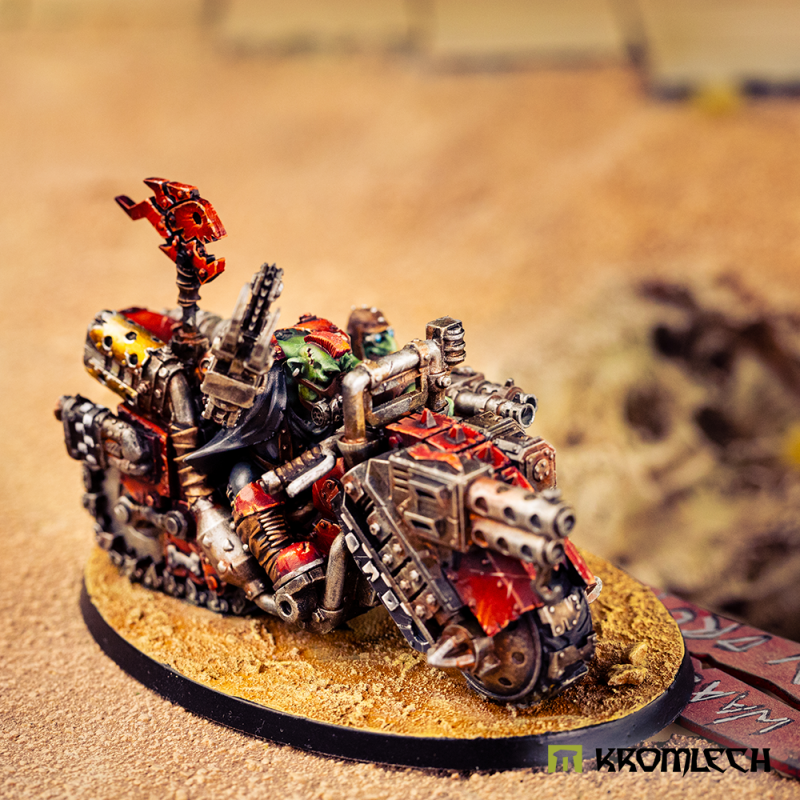 The painted bike on a sandy base, seen from the front corner