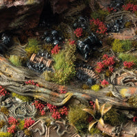 Scenic diorama decorated with red Poppy Tiny Flowers tufts among grass and terrain