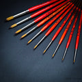 Raphael 8394 Kaerell round synthetic brushes arranged in a fan display showing multiple sizes
