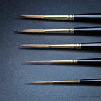 Close-up of Raphael 8802 Kolinsky Sable Rigger brush tips showing ultra-fine precision for model painting and illustration