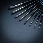 Close-up of Raphaël Softaqua 845 round brushes showing fine pointed synthetic squirrel tips for detailed watercolour work