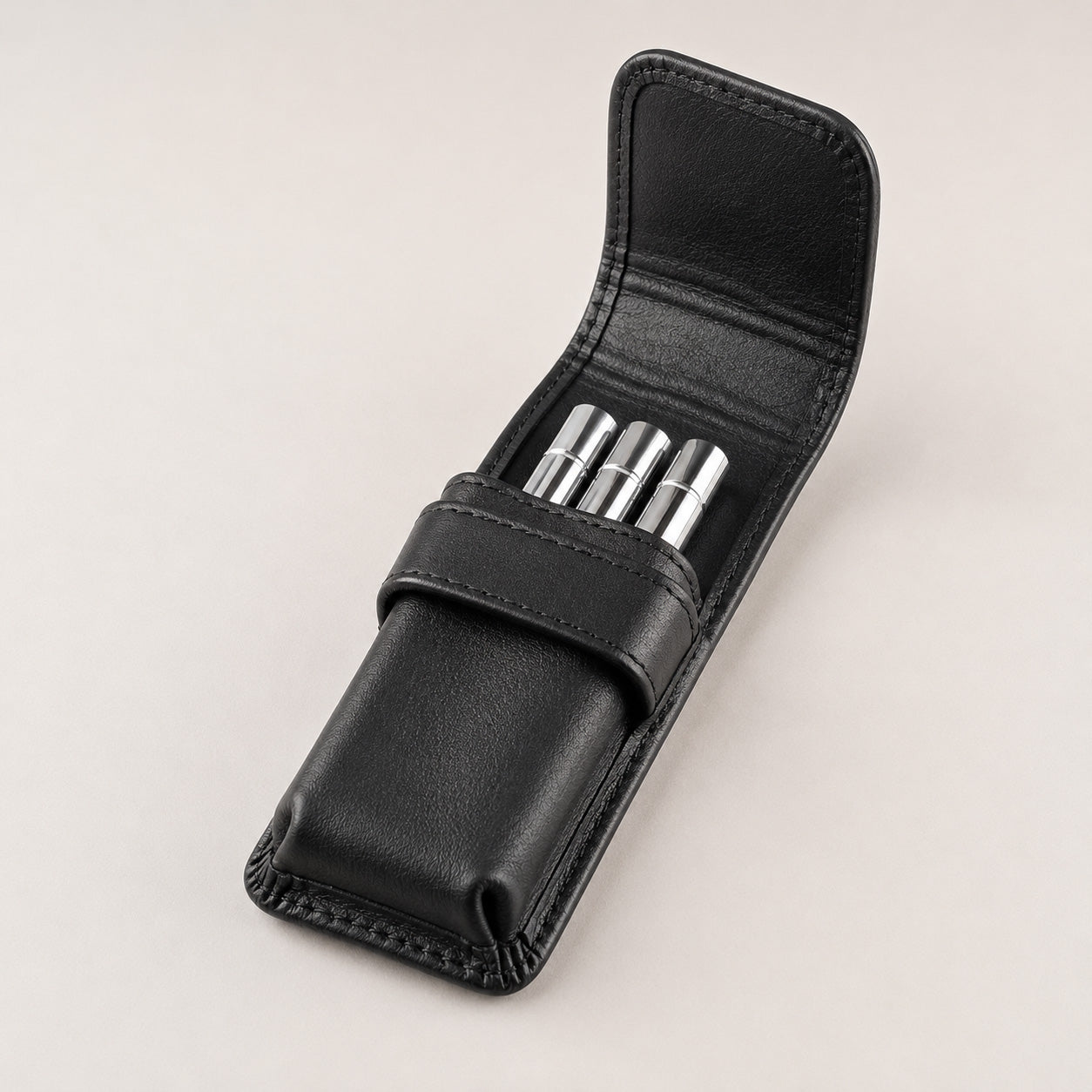 Open Rosemary & Co 3 pocket leather brush wallet showing short travel brushes stored in individual pockets