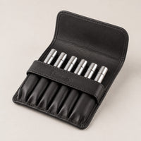 Open Rosemary & Co black leather 6 pocket brush wallet showing short travel brushes stored in individual sleeves
