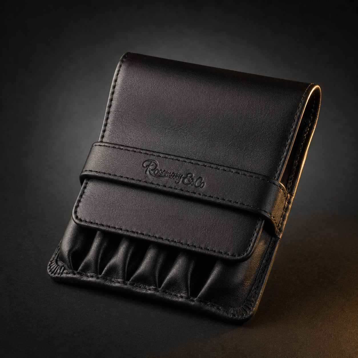 Rosemary & Co black leather 6 pocket brush wallet shown closed for storing short pocket travel brushes