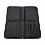 Open Rosemary & Co black nylon brush case showing empty brush dividers, elastic loops and zip-around storage layout