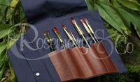 Open Rosemary & Co long handle leather fabric brush wrap showing artist brushes stored in individual pouches
