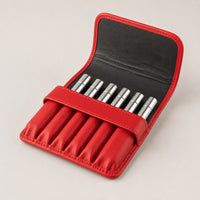 Open Rosemary & Co red leather 6 pocket brush wallet showing short travel brushes stored in individual sleeves
