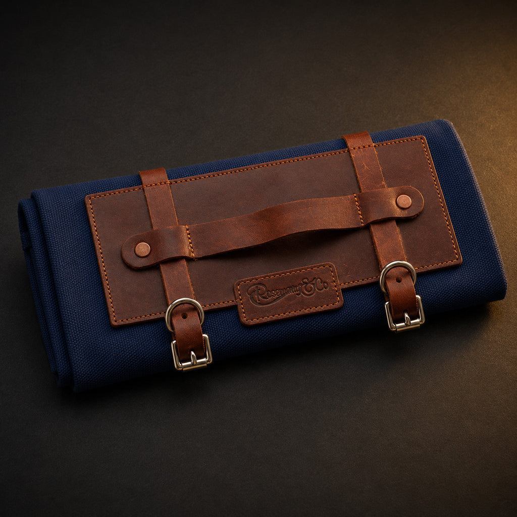 Rosemary & Co short handle leather fabric brush wrap shown closed with navy canvas body, tan leather panel and buckle straps
