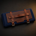 Rosemary & Co short handle leather fabric brush wrap shown closed with navy canvas body, tan leather panel and buckle straps