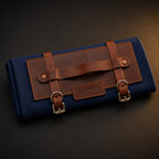 Rosemary & Co short handle leather fabric brush wrap shown closed with navy canvas body, tan leather panel and buckle straps