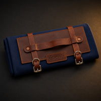 Rosemary & Co short handle leather fabric brush wrap shown closed with navy canvas body, tan leather panel and buckle straps
