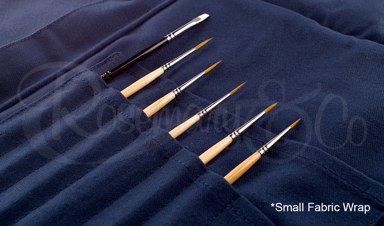 Close-up of Rosemary & Co small navy fabric brush wrap with brushes stored in stitched canvas pouches