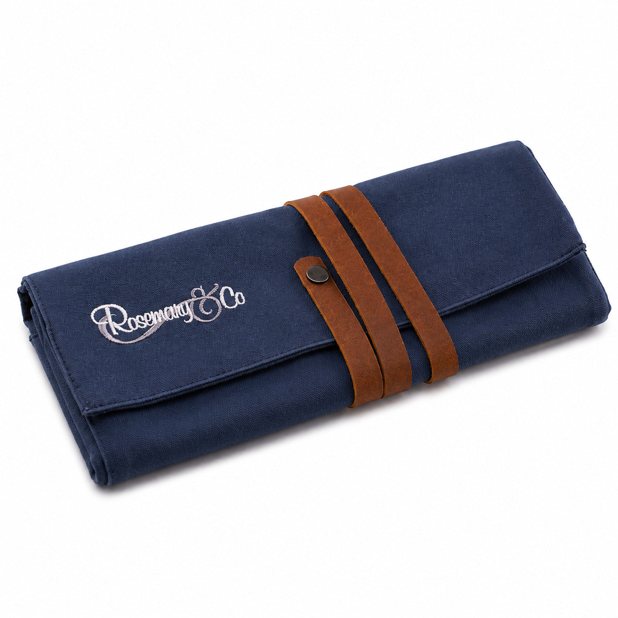 Closed Rosemary & Co small navy canvas brush wrap with wrap-around leather strap and press-stud closure