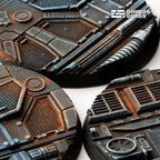 Extreme close-up of 50mm Spaceship Corridor bases: rust bloom over blue-grey plating, mesh panels and louvred vents