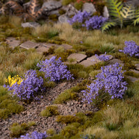 Lifelike diorama featuring Violet Flowers - Wild tufts, showcasing a vibrant landscape with varied textures, including lavender fields, rhododendron bushes, and colorful garden flowers
