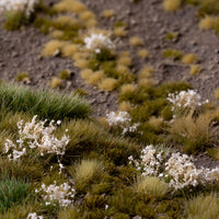 Lifelike diorama featuring White Flowers - Wild tufts, showcasing a realistic blooming landscape with varied textures, including heathland, wild roses, and garden flowers
