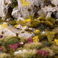 Vibrant countryside diorama featuring the Wild Flowers Set, showcasing a diverse wildflower landscape with heathers, brooms, and colorful meadow flowers
