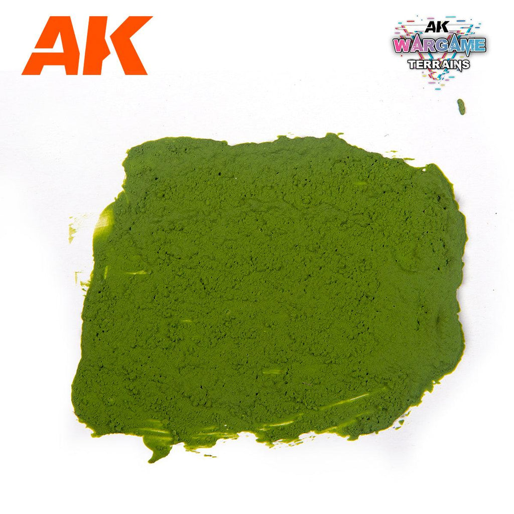 A spread swatch of AK1217 Plague Ground on white, a grainy olive-green soil surface