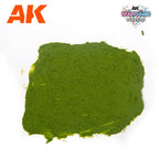 A spread swatch of AK1217 Plague Ground on white, a grainy olive-green soil surface