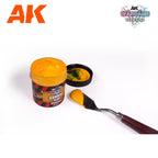 AK1221 Sunrise Blaze jar open beside its lid, brimming with bright orange paste, with a loaded palette knife alongside