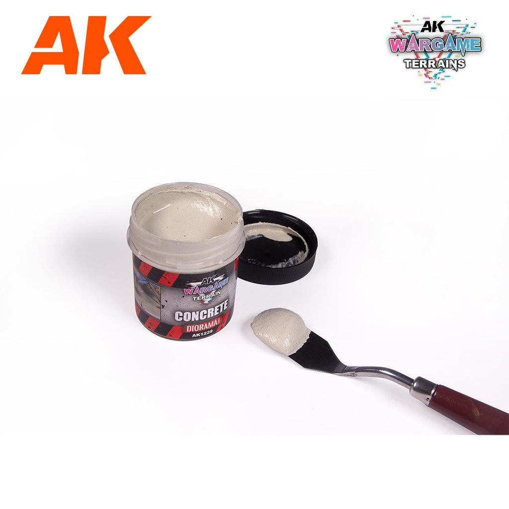 AK1229 Concrete jar open beside its lid, full of pale grey paste, with a loaded palette knife alongside