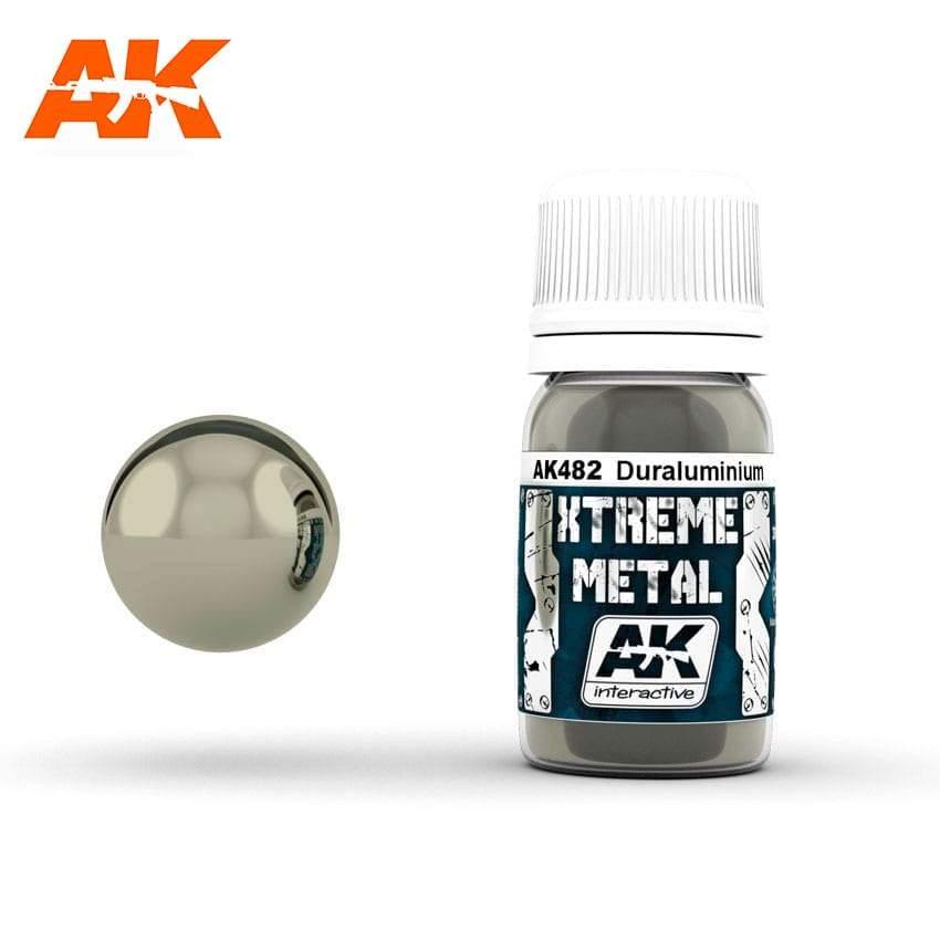 AK482 Xtreme Metal Duraluminium: 30ml bottle with a ribbed white cap, beside a glossy pale champagne-grey metal sphere.