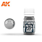AK670 Xtreme Metal Stainless Steel: 30ml bottle with a ribbed white cap, beside a bright neutral silver-grey mirror sphere.
