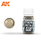 AK672 Xtreme Metal Pale Brass: 30ml bottle with a ribbed white cap, beside a mirror-bright pale champagne gold sphere.