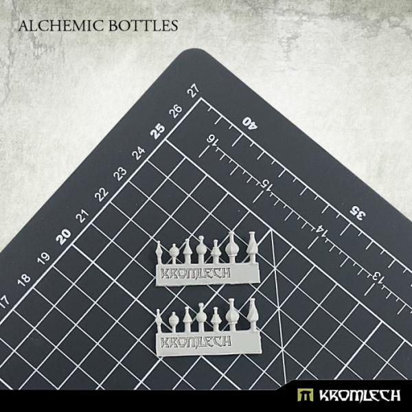 Two resin sprues of Kromlech Alchemic Bottles on cutting mat with Kromlech-branded casting frames