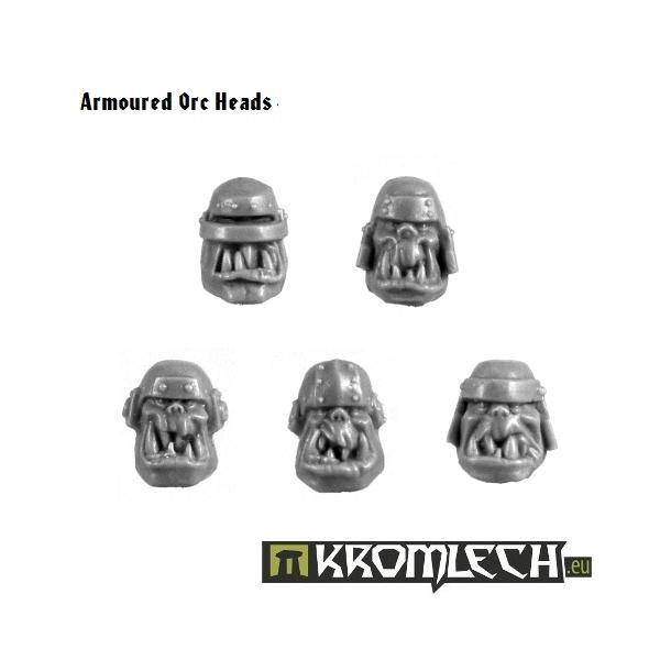 Five unpainted Kromlech Armoured Orc Heads showing helmeted designs with tusks and jaw guards