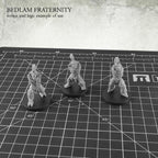 Kromlech Bedlam Fraternity torsos and legs example of use three assembled unpainted miniatures on cutting mat
