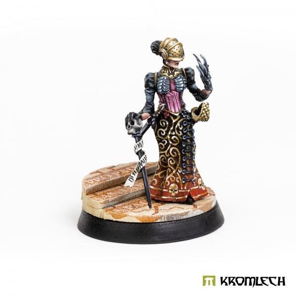 Painted miniature on a round base with Kromlech Cathedral topper applied and painted in sandstone tones